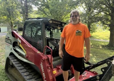 Shear Performance team member beside the forestry mulcher